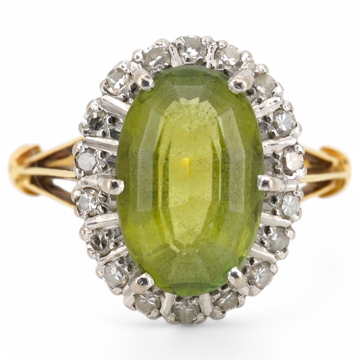 An 18ct, peridot and diamond set oval cluster ring, size K/L, gross weight 4.1 grams. Condition - poor to fair